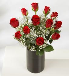 Red roses bouquet with small white flowers in chic black vase.JPG