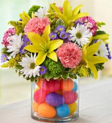 Colorful Easter flowers center piece with bright colored plastic eggs.JPG