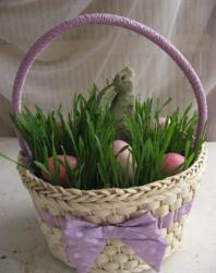 Cute Easter gifts picture of a basket with grass eggs and a bunny standing among the grass and Easter eggs.JPG