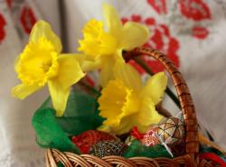 Easter basket with yellow Easter flowers and beautiful Easter eggs with painted patterns.JPG