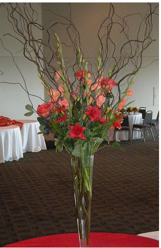Picture of tall slime wedding centerpiece with flowers and branches.PNG
