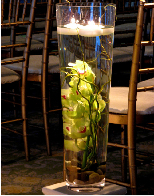 Tall glass wedding arrangement with green orchid flwoers.PNG
