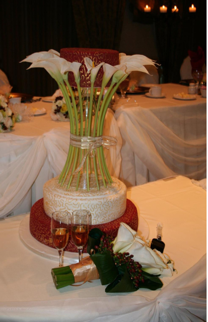 Wedding cake with white lilies flowers and bridal bouquet.PNG