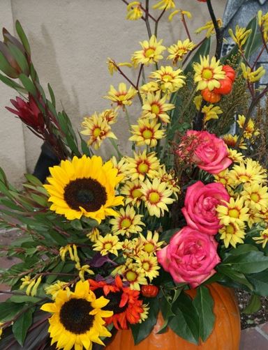 Colorful Halloween flowers centerpiece with fresh pumpkin.JPG