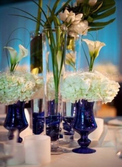 2015 wedding centerpieces with blue vases and white flowers.JPG