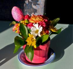 Cute Easter flowers gift with fresh bright colored flowers with easter egg