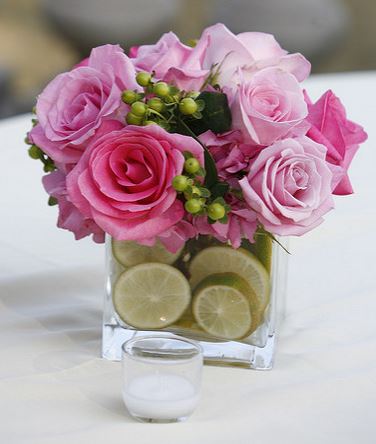 Square wedding centerpiece with pink roses and lime slides in the vase