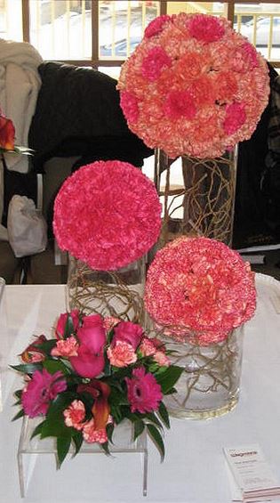Modern wedding arrangements with tall glass vases and pink flowers