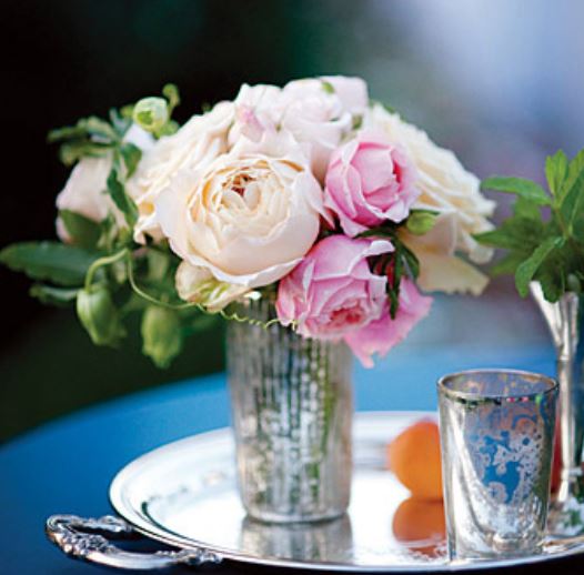 Beautiful wedding flowers with shinny vase on mirror tray