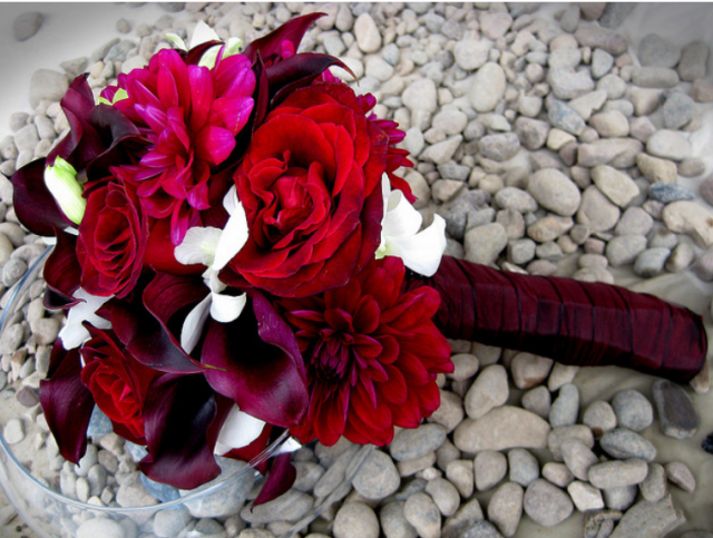 Romantic looking wedding bouquet with flowers and some small white flowers.PNG