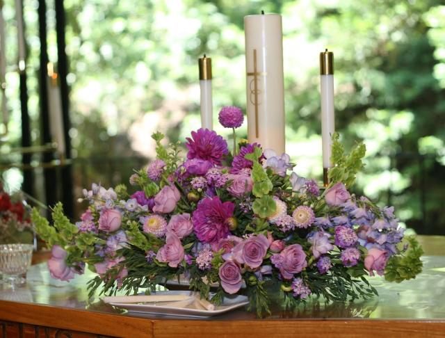 center pieces for a wedding with purple flowers and candals.jpg