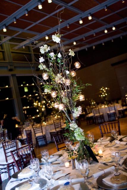 wedding center pieces with with white flowers and candles.jpg