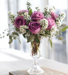 Purple roses and small white flowers arrangement with tall glass vase photos.JPG